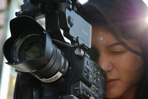 Woman behind a large video camera